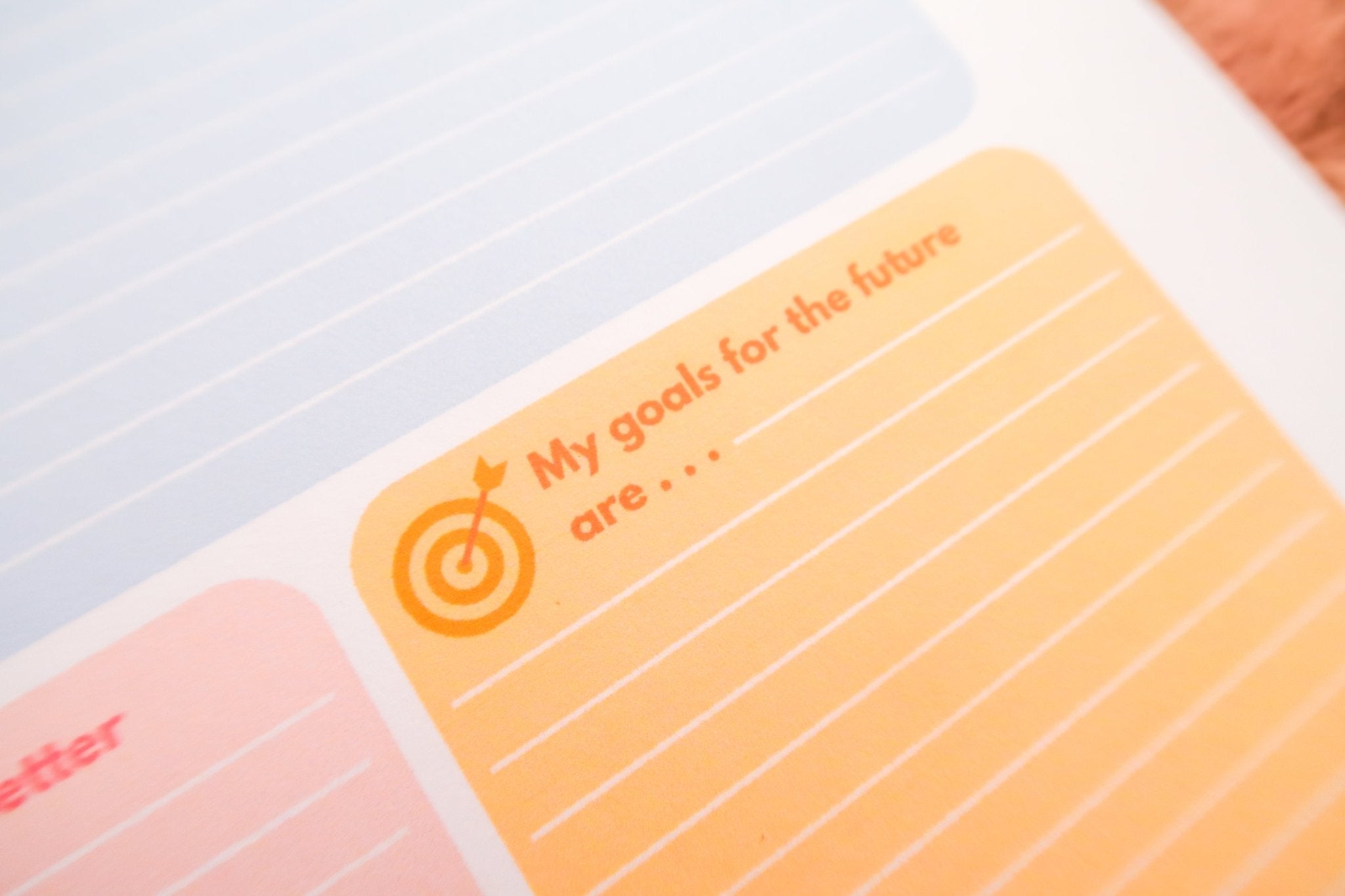 Another angle of Totepad's Bubblegum Daily Reflection Notepad showcasing the warm yellow goal-setting space.
