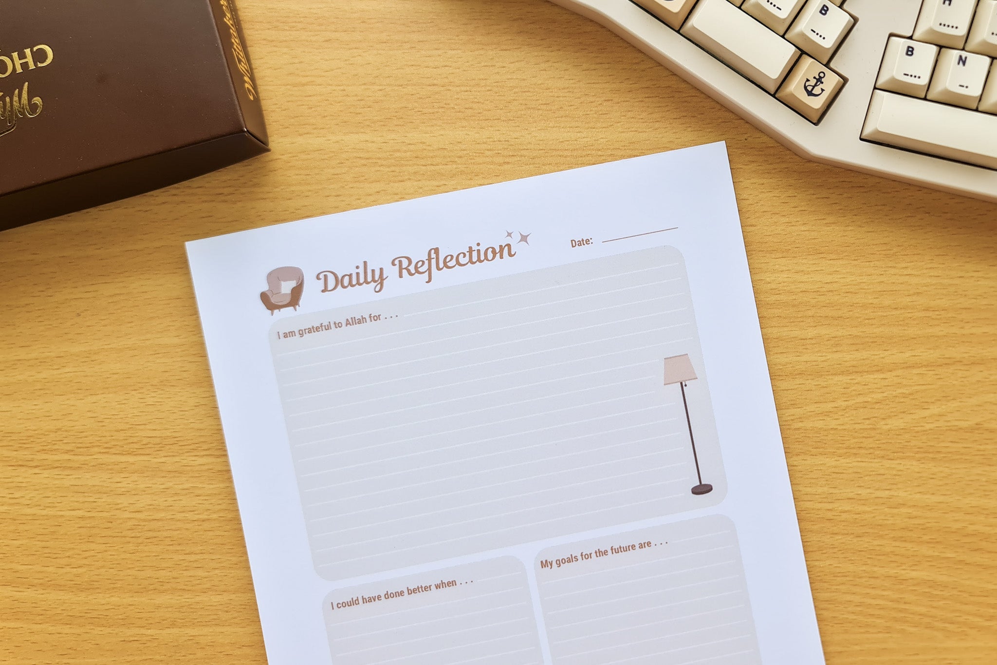 Totepad's Cocoa Daily Reflection Notepad on a warm wooden desk and a box of chocolates.