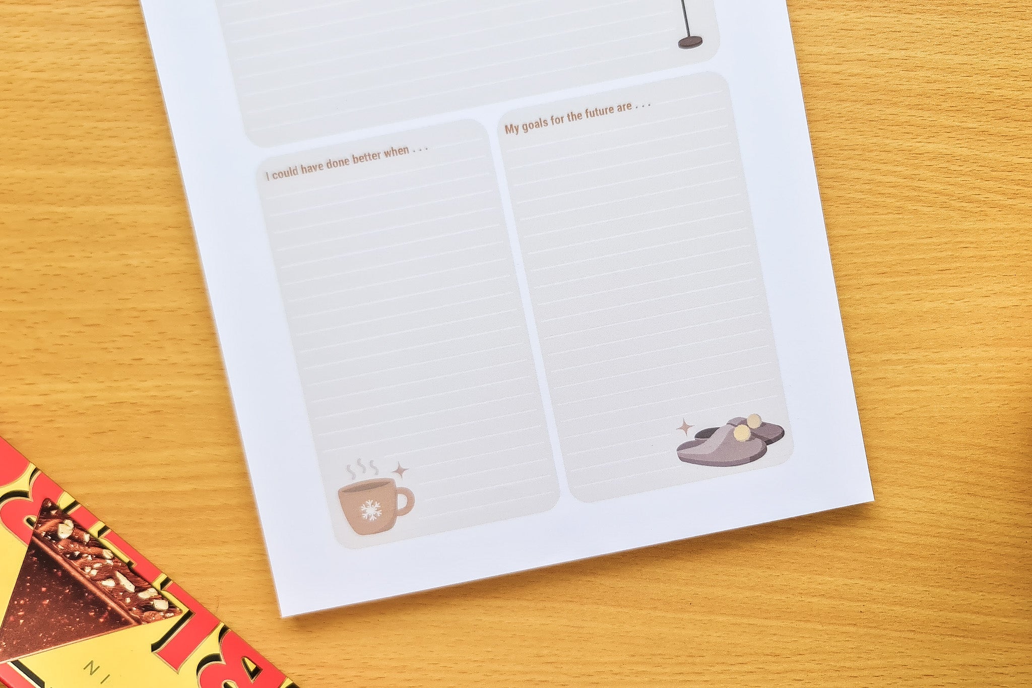 Another angle of Totepad's Cocoa Daily Reflection Notepad, showcasing a hot choco and fuzzy slippers motif.