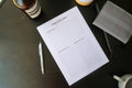 Totepad's A4 Luxury Daily Reflection Notepad on a black table, tastefully laid out with a planner and stationery.