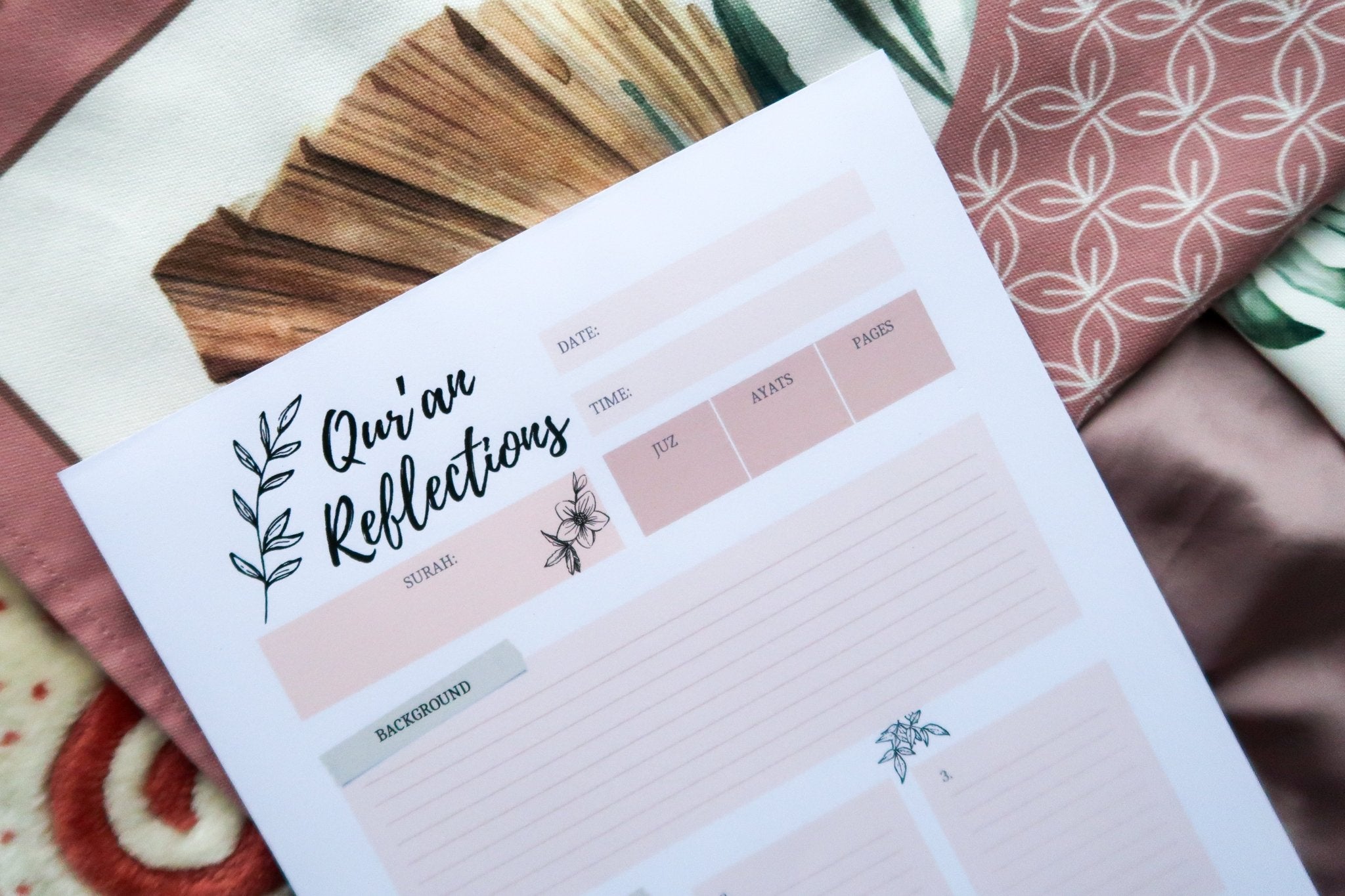 Totepad's Quran Reflections Notepad on a pastel pink prayer mat.